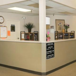 A reception desk area with office decor and organizational elements.