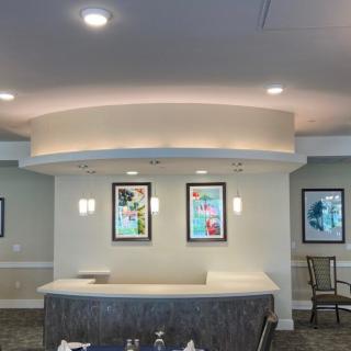 A modern reception area with framed artwork and recessed lighting.