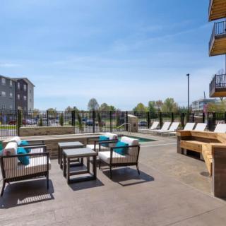 Modern outdoor patio area with comfortable seating and a view of nearby buildings.