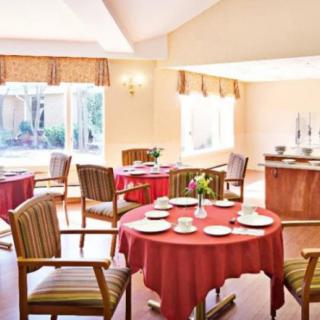 A well-lit dining area with tables set for a meal.