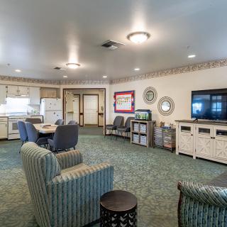 A cozy living space with a kitchen, seating area, and television.