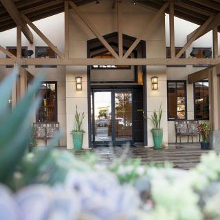 Entrance to a building with potted plants and architectural details.