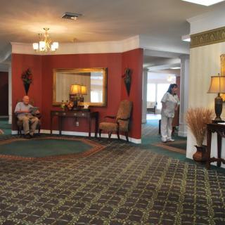 A spacious lobby with seating, decorative elements, and a carpeted floor.