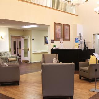 A comfortable and spacious lobby area with seating and a reception desk.