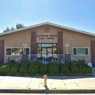 The image shows the exterior of a community center building on a sunny day.