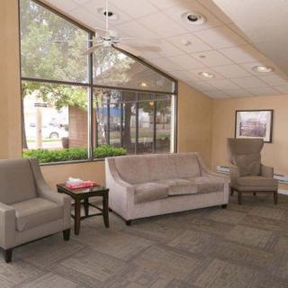 A cozy lobby area with seating and large windows.