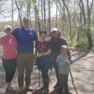 A joyful family outing in nature, enjoying the beautiful spring weather during a hike.