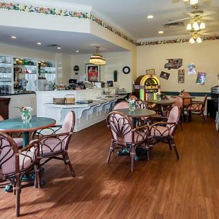 A quaint cafe interior with vintage decor and a jukebox.