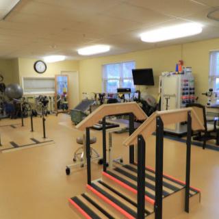 A physical therapy room equipped with various rehabilitation tools and exercise equipment.