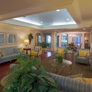 A cozy and elegantly designed living room with plush sofas, a coffee table, and decorative plants.
