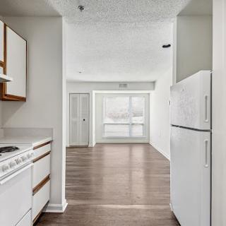 A view of an open-concept kitchen leading into a spacious living area.