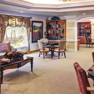 A cozy living room with comfortable seating, bookshelves, and tasteful decor.