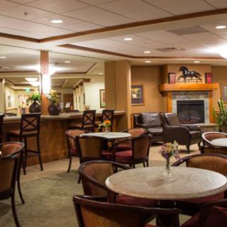 A cozy indoor lounge with dining tables and chairs, perfect for relaxation.