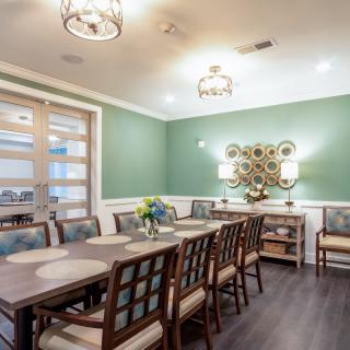 A modern dining room with elegant furniture and sophisticated lighting.