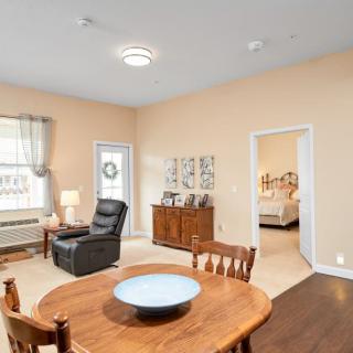 A cozy living room with a dining area featuring wooden furniture and tasteful decor.