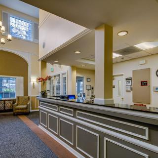 A well-lit reception area with a front desk and comfortable seating.