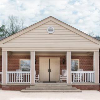 A suburban house with a front porch and columns.