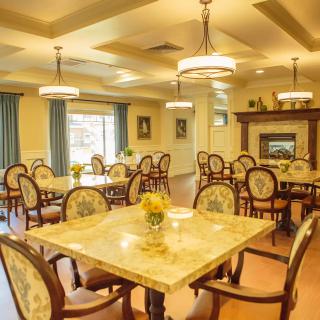 A cozy dining room with elegant furnishings and warm lighting.
