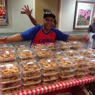 A joyful display of delicious cookies on a table, shared by an enthusiastic person.