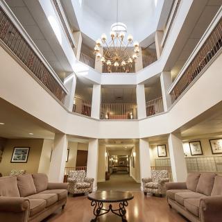 Elegant hotel lobby featuring a grand chandelier and comfortable seating.