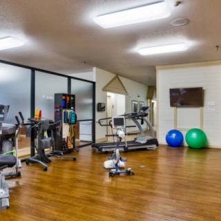 A well-equipped gym with various exercise machines and fitness equipment.
