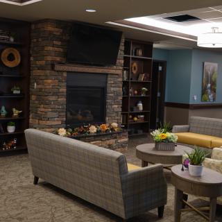 A cozy living room with a fireplace and modern decor.
