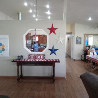 A cozy home interior featuring a decorated living space with stars and a welcoming table.