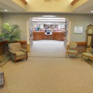 A lobby area featuring comfortable chairs and a view of the reception desk.