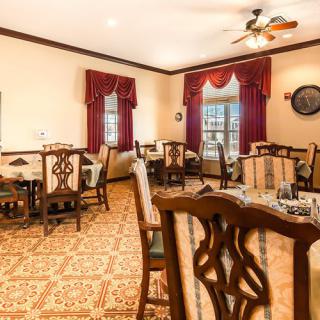 A traditional dining room with wooden furniture and elegant decor.