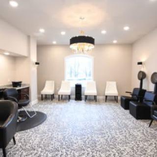 A modern salon interior with stylish lighting and comfortable seating.