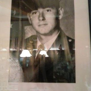 A vintage black and white portrait of a serviceman in military uniform.