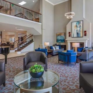 A modern lobby with comfortable seating, a fireplace, and stylish decor.