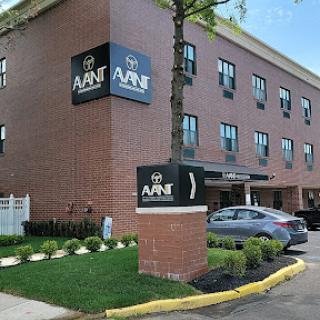 Exterior view of a hotel with modern signage and landscaped surroundings.