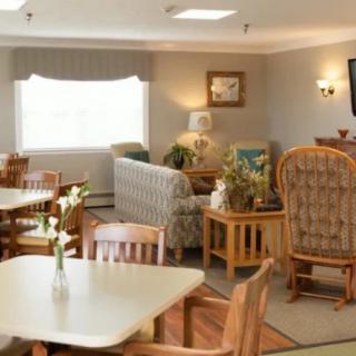 A cozy and well-decorated living room with various seating options and a television.
