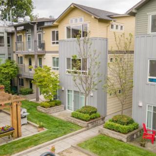 A view of a modern apartment building with landscaped gardens and walkways.