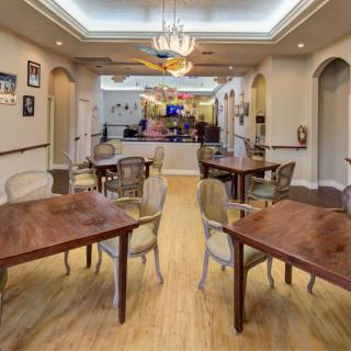 A beautifully designed dining area with elegant furniture and warm lighting.