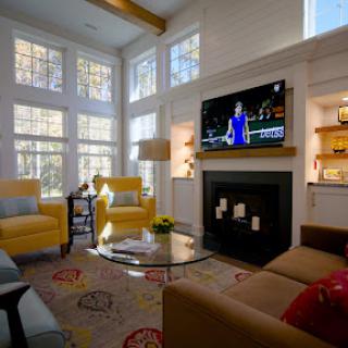 A bright and inviting living room featuring modern furnishings, a cozy fireplace, and ample natural light.