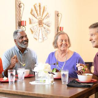 A cheerful gathering of friends enjoying a meal together.