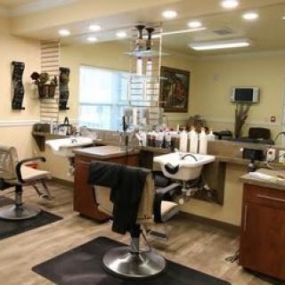 A well-equipped hair salon interior with chairs, mirrors, and hair styling stations.