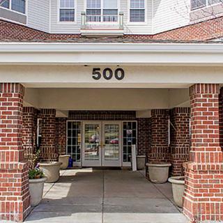 A brick building entrance with the number 500 displayed above the doorway.