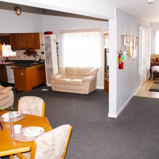 Open-concept living area featuring a dining table, kitchen, and cozy seating.