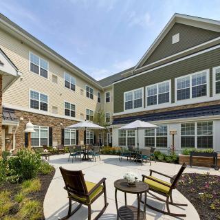 A modern residential courtyard with outdoor seating and greenery.