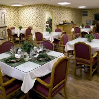 An elegantly decorated dining room with tables set for a meal.