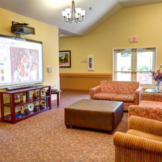 A cozy living room with comfortable seating and a projector screen.
