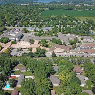 Aerial view of a suburban community showcasing residential areas and lush greenery.