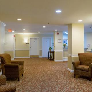 A cozy lobby area featuring comfortable chairs and warm lighting.