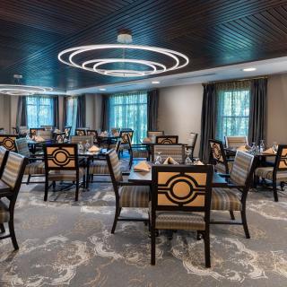 A modern dining room with elegant decor and stylish lighting.