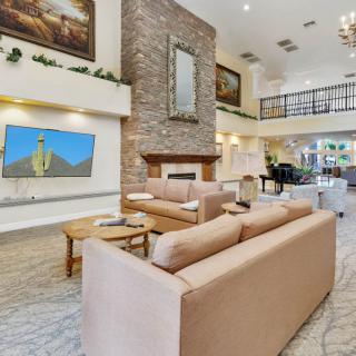 A modern and luxurious living room with comfortable seating, a fireplace, and elegant interior design.