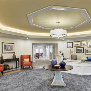 A well-designed lobby area featuring elegant furniture and artwork on the walls.