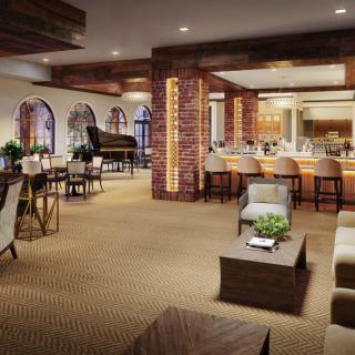 A spacious and elegantly designed lounge with a bar, comfortable seating, and a grand piano.